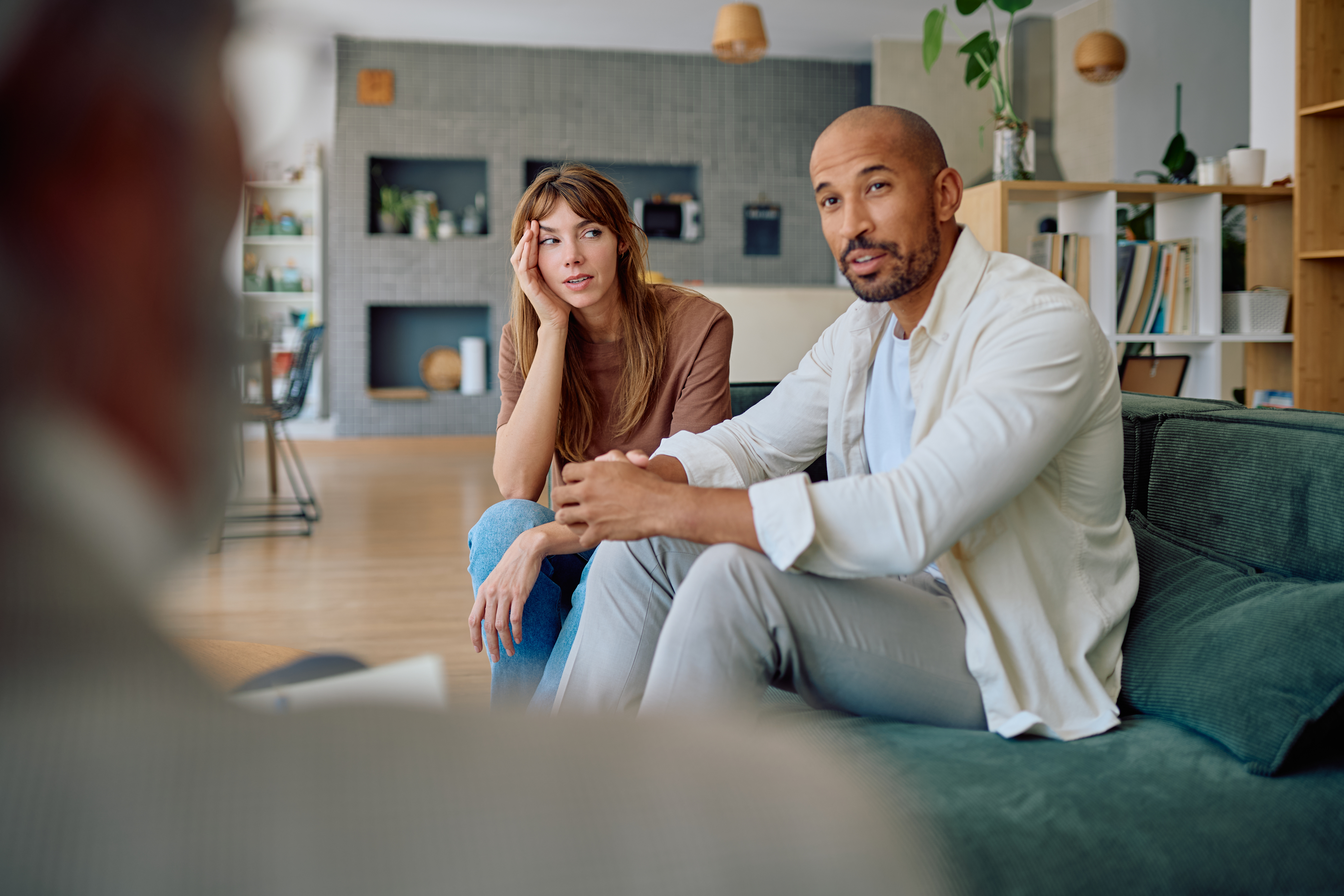 Couple discussing relationship goals with their therapist in a supportive setting